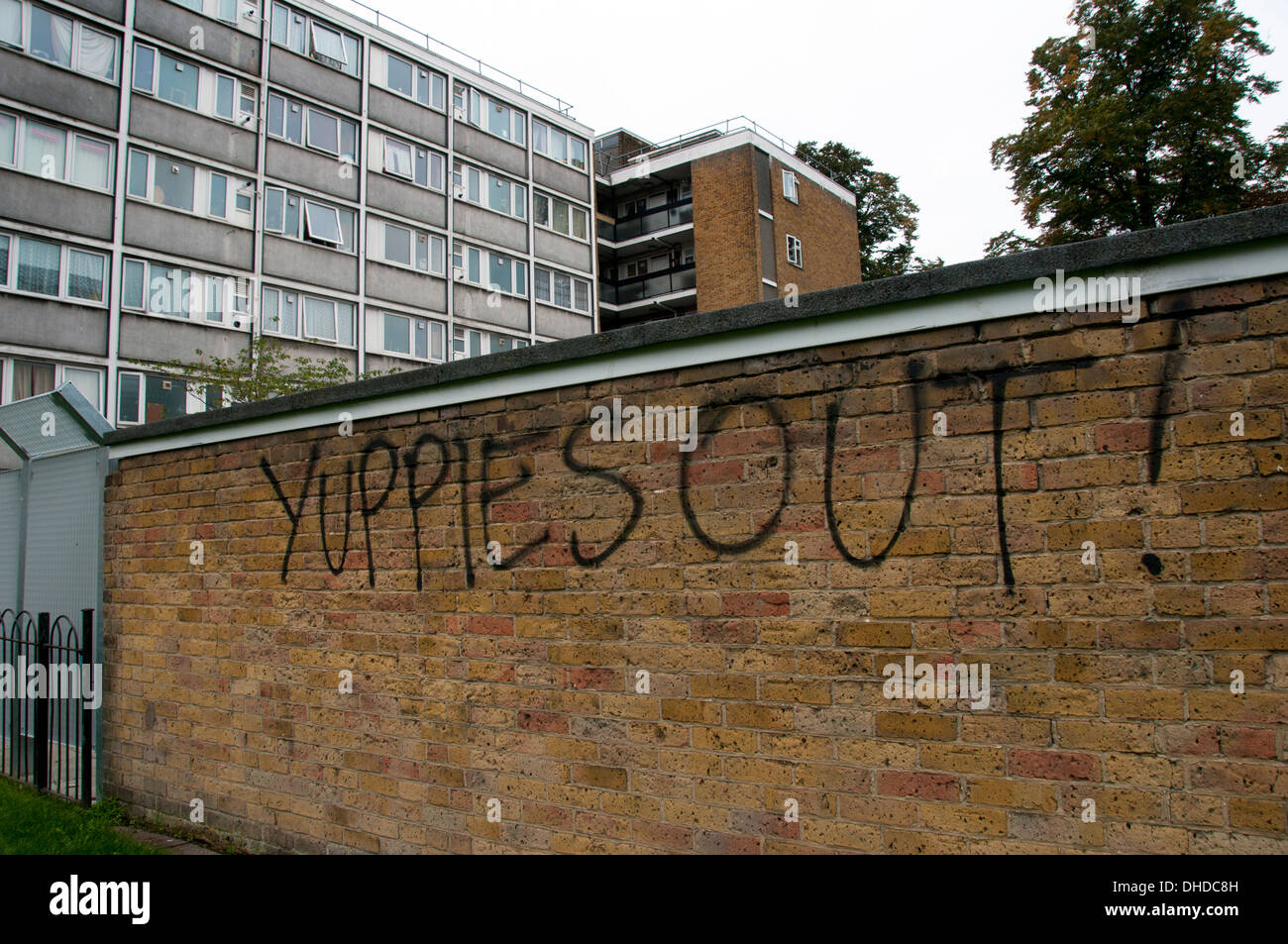 Class War graffiti writing on wall of housing estate saying Yuppies Out Stock Photo