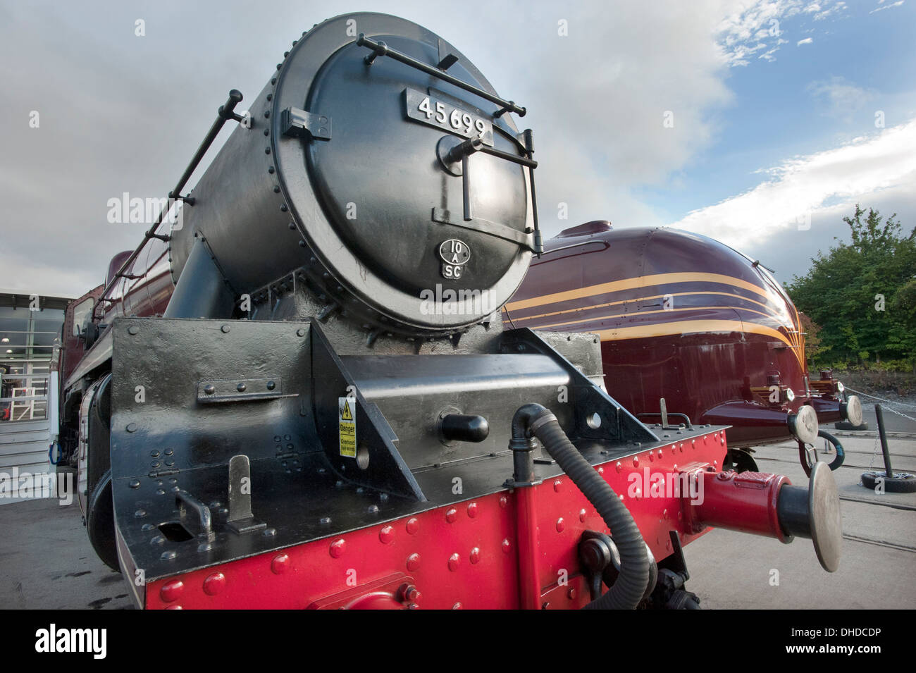 LMS (London Midland Scottish) Julbilee class steam locomotive 45699, 'GALATEA' stands in front of Streamlined LMS 'Princess Coronation' class No.6229 'Duchess of Hamilton' at the National Railway Museums overflow museum at Shildon, County Durham. Stock Photo