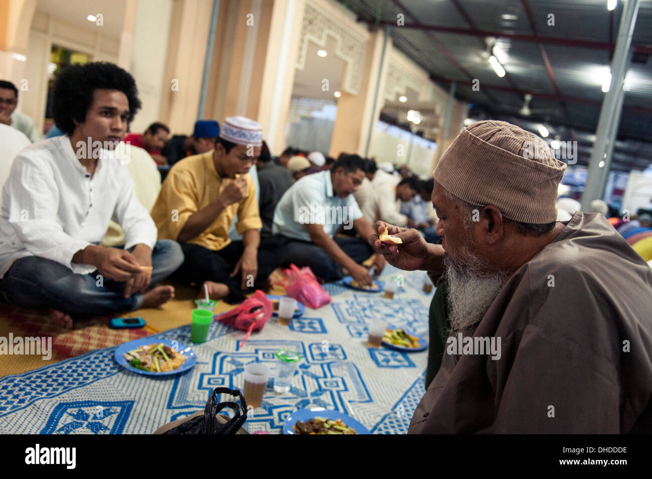 Muslims break the fast (iftar), Kampung Baru Mosque, Kuala Lumpur, Malaysia, Southeast Asia, Asia Stock Photo