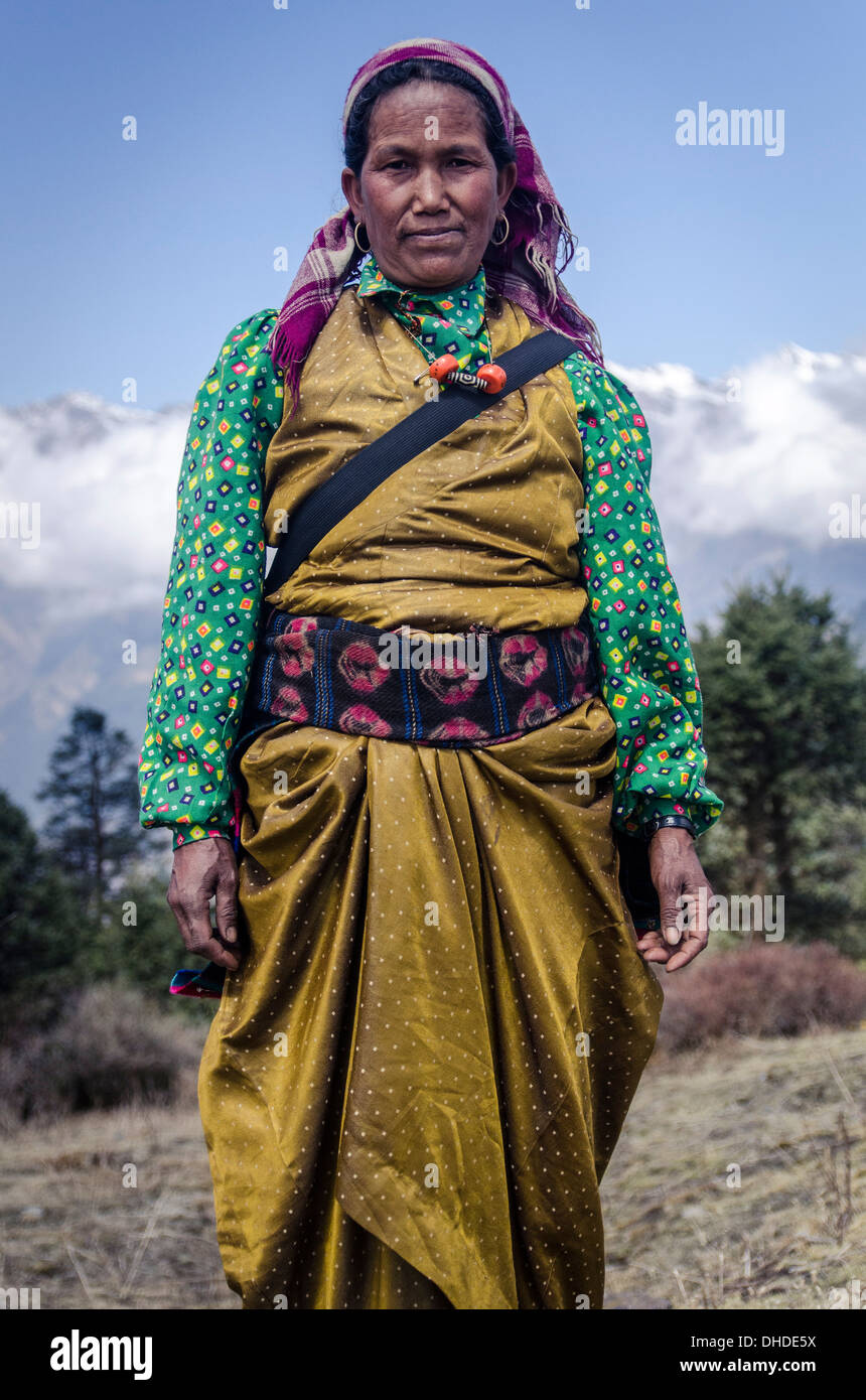 A woman wearing traditional dress in front of the Himalaya mountains, Mere Danda, Helambu, Nepal, Asia Stock Photo