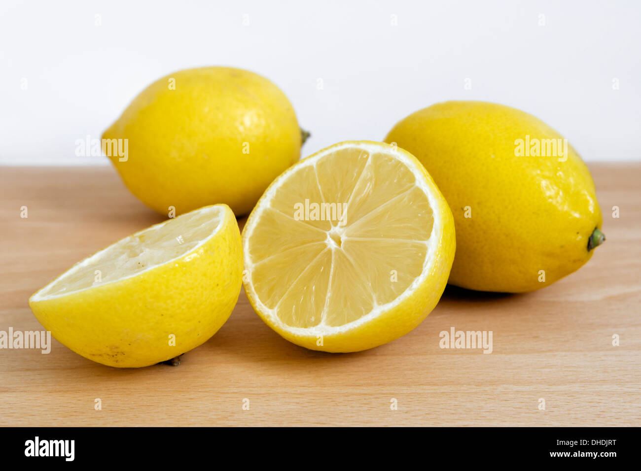 Fresh lemons on chopping board Stock Photo