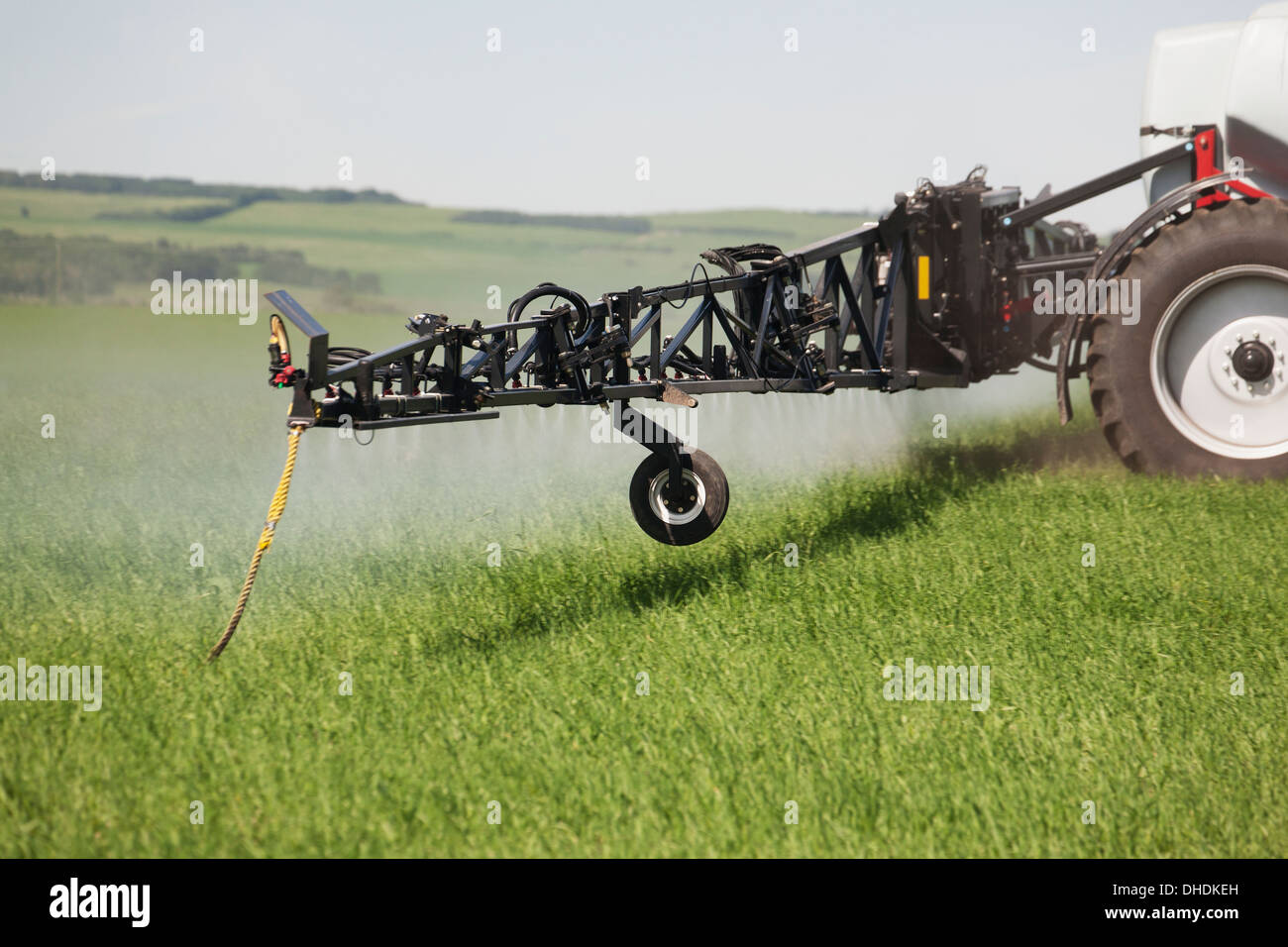 Close Up Of Sprayer, Spraying In A Young Green Barley Field; Sylvan Lake, Alberta, Canada Stock Photo
