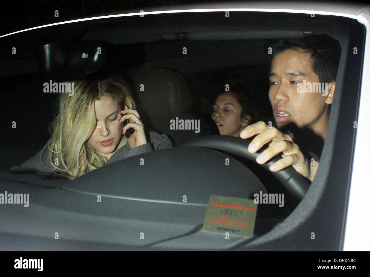 Riley Keough chats on her mobile phone in car as she leaves Chateau