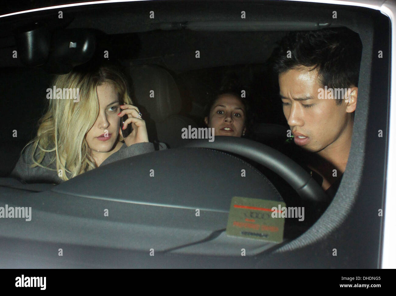 Riley Keough chats on her mobile phone in car as she leaves Chateau