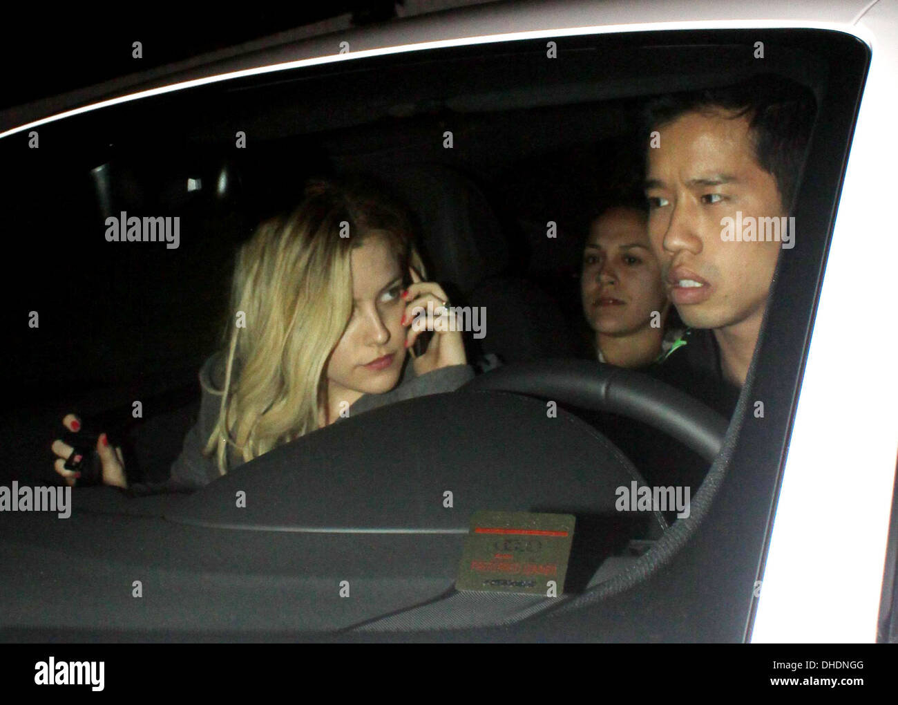 Riley Keough chats on her mobile phone in car as she leaves Chateau