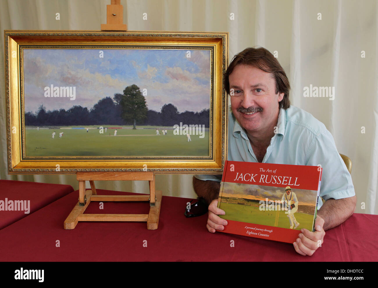 Jack Russell, cricketer and artist, promotes his book while sitting next to one of his paintings of the Canterbury Lime Tree. Stock Photo