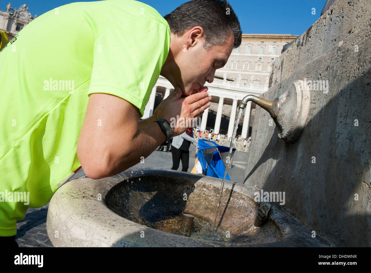 Athlete drinking in St Peter's Square before the race Stock Photo