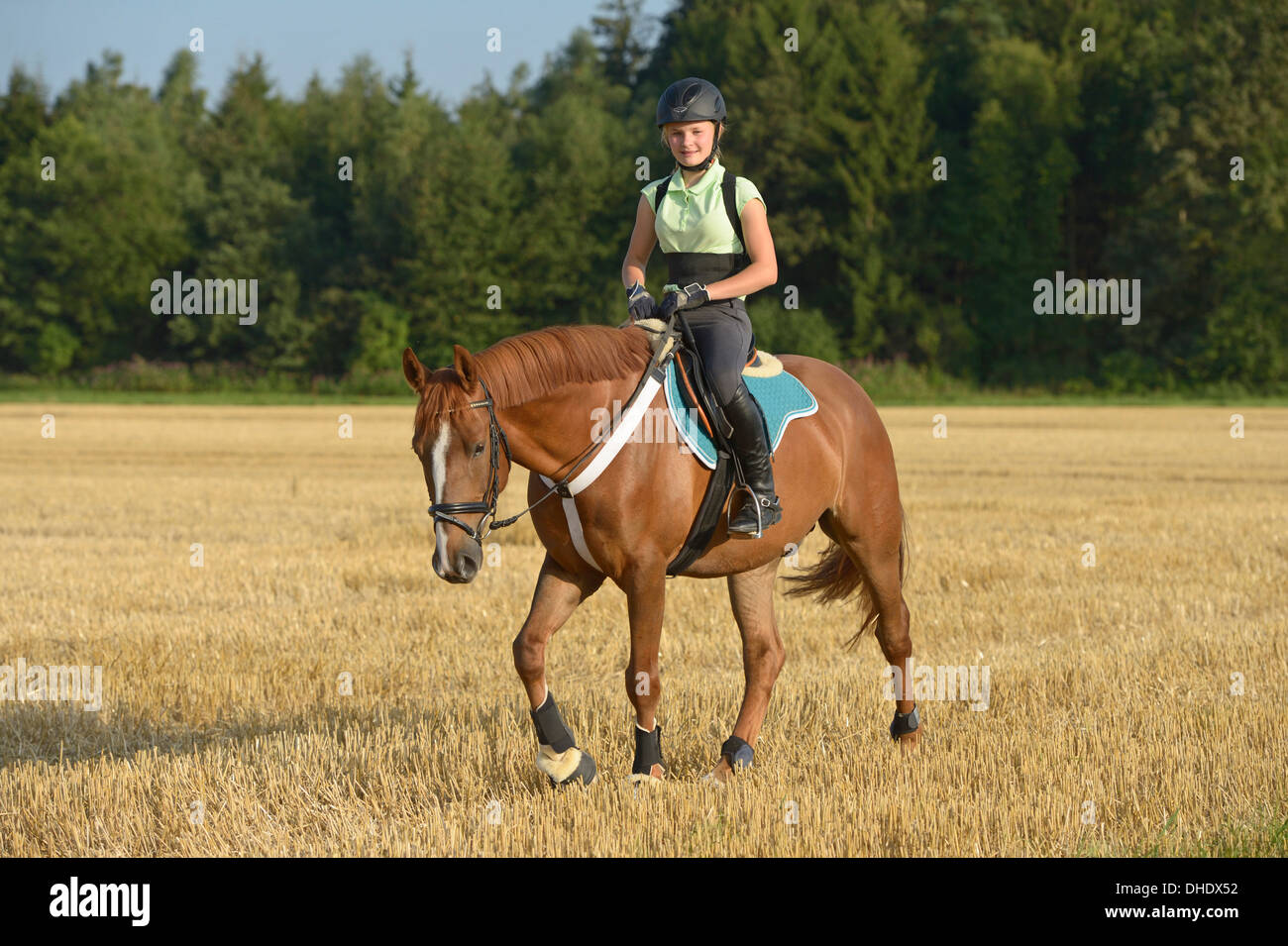 Thirteenyearold girl wearing a helmet and a back protector on back of