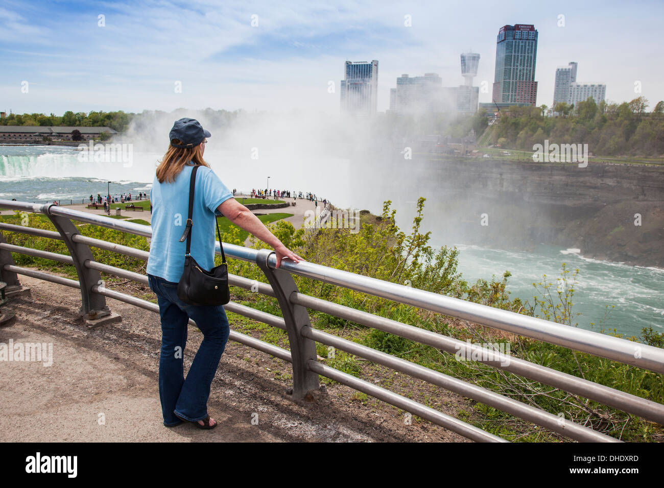 A Woman Stands At A Railing Overlooking Horseshoe Falls At Niagara