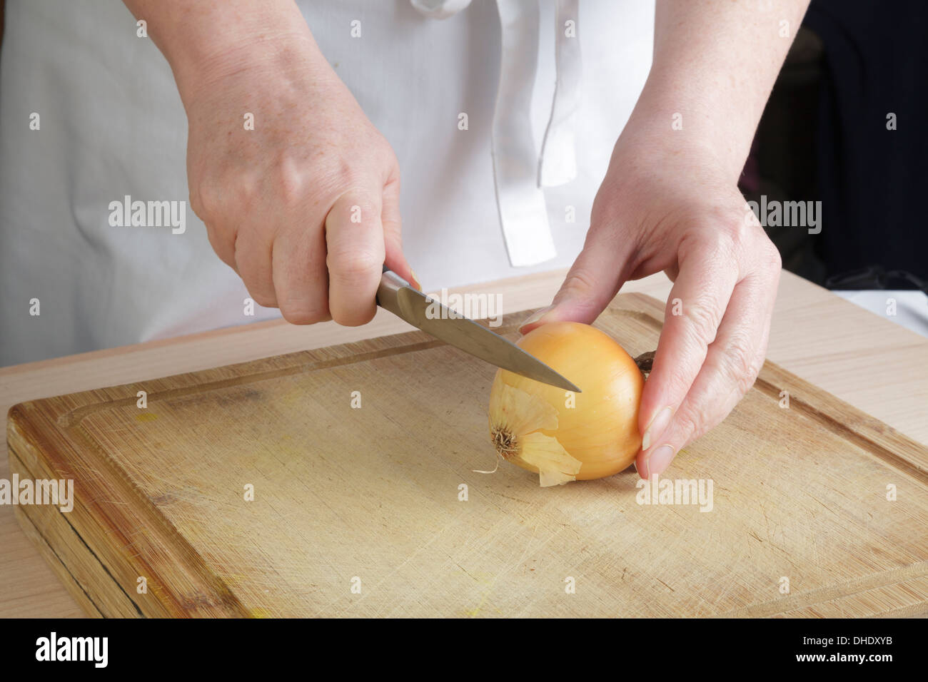 Cook chopping an onion Stock Photo