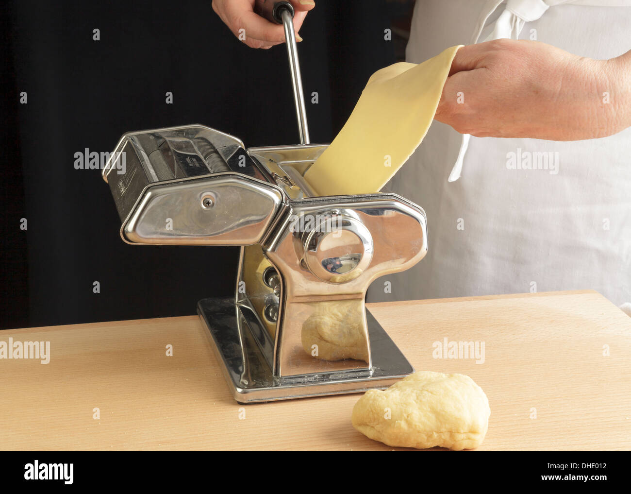 rolling pasta sheets with a machine Stock Photo