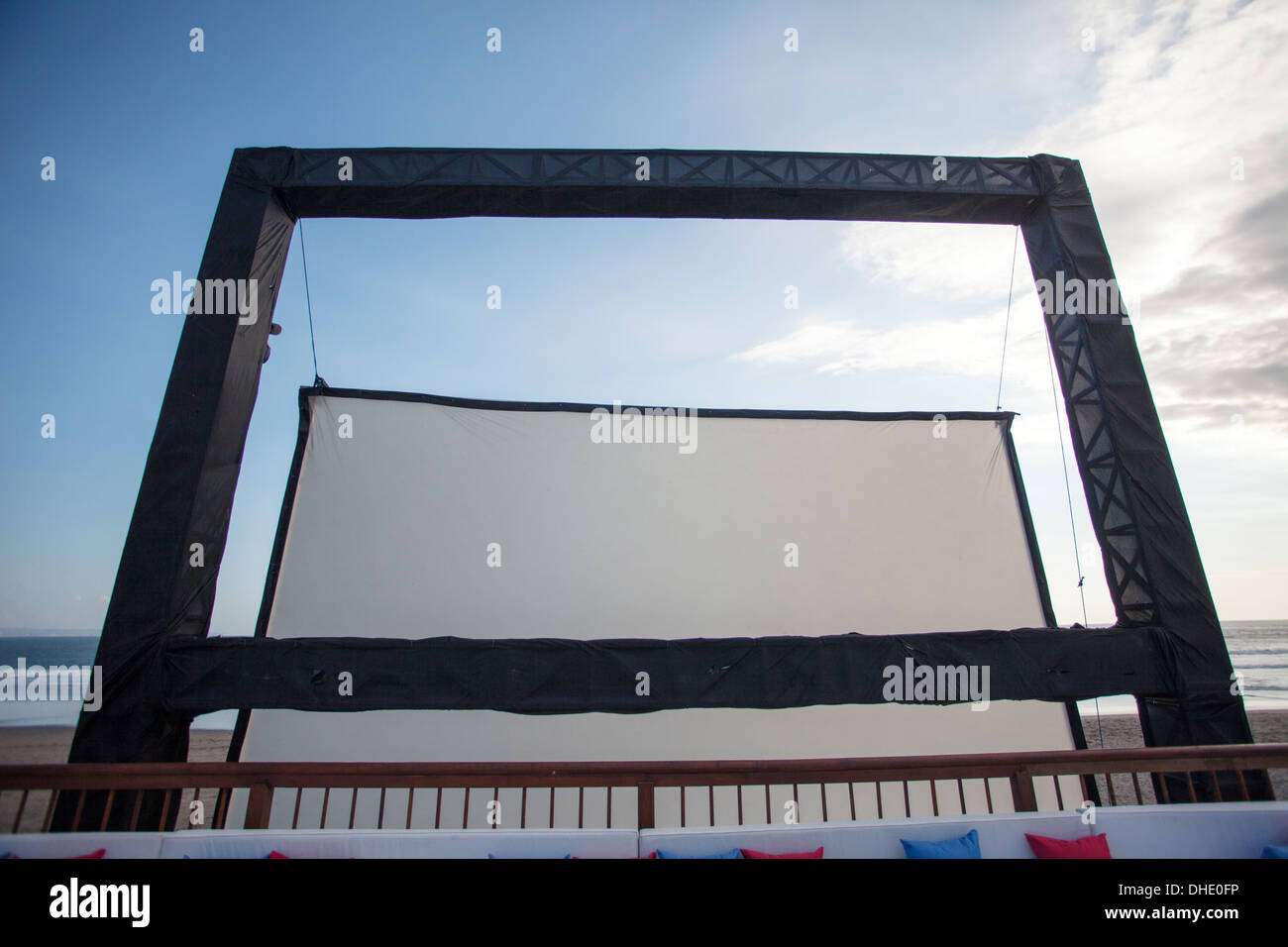 Outdoor cinema screen erect beach cloth frame day create black sun