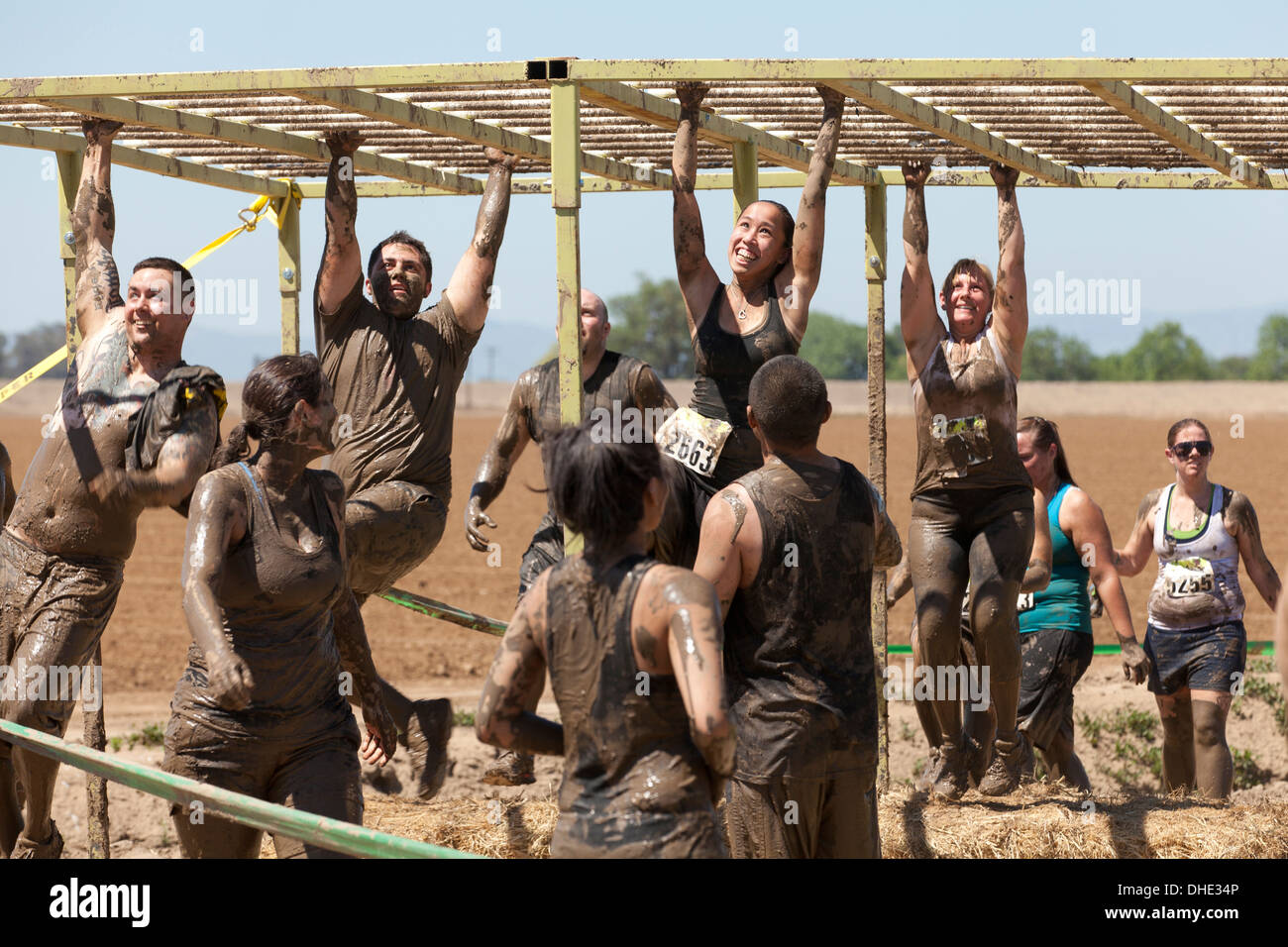 Mud run participants on obstacle course California USA Stock Photo