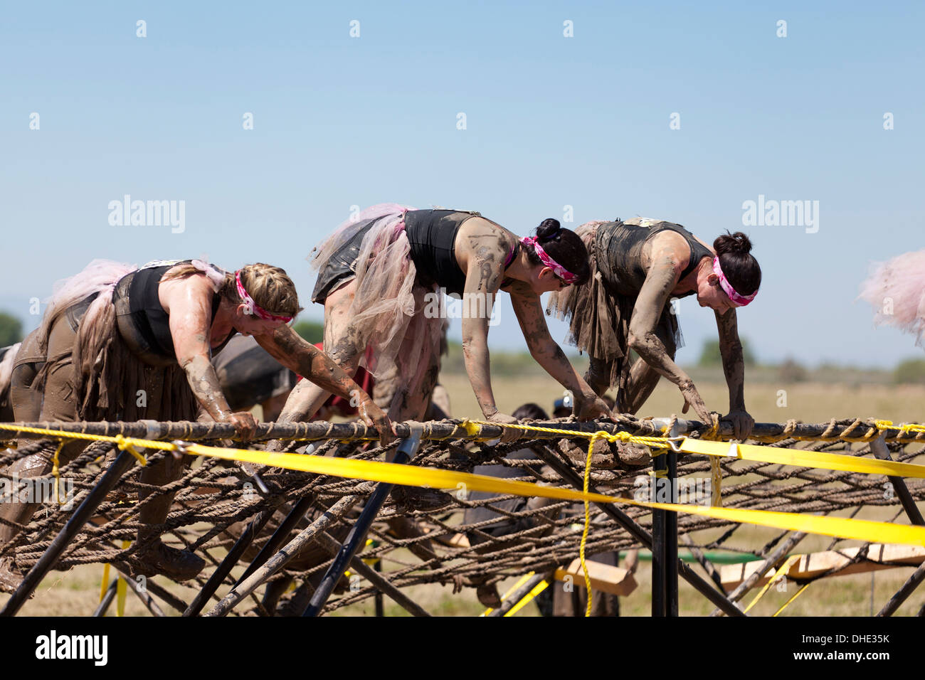 Female mud runners on obstacle course - California USA Stock Photo