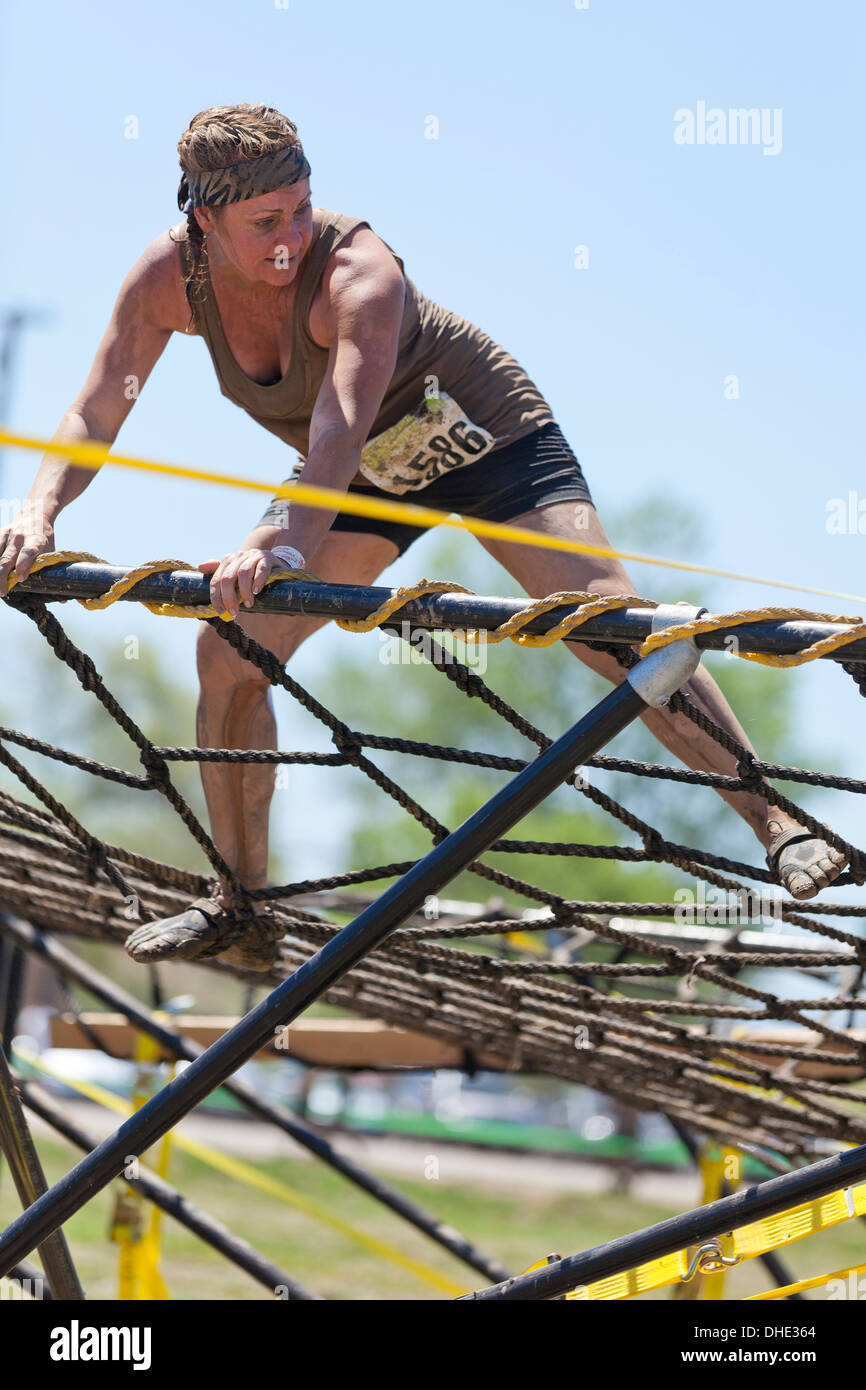 Mud run participant on obstacle - California USA Stock Photo