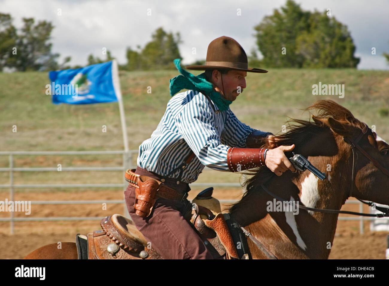 Cowboy with gun on horse, mounted shooting competition, End of Trail Wild West Jubilee, near Albuquerque, New Mexico USA Stock Photo