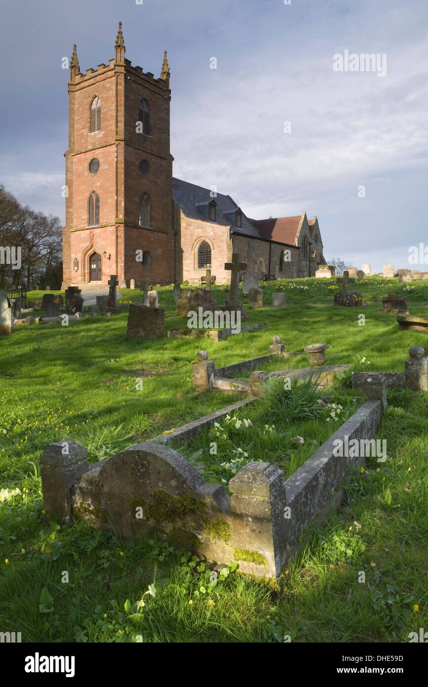 St Mary the Virgin Church Hanbury. The low sun at sunset casts long shadows on the graves in the graveyard. Stock Photo