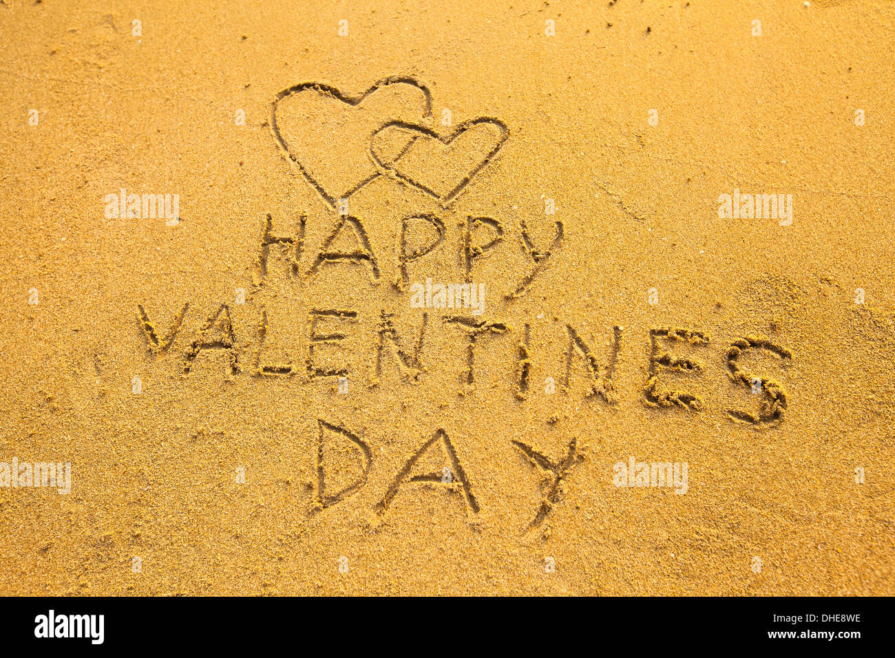 Happy Valentine's Day and two hearts - In the beach sand Stock Photo ...