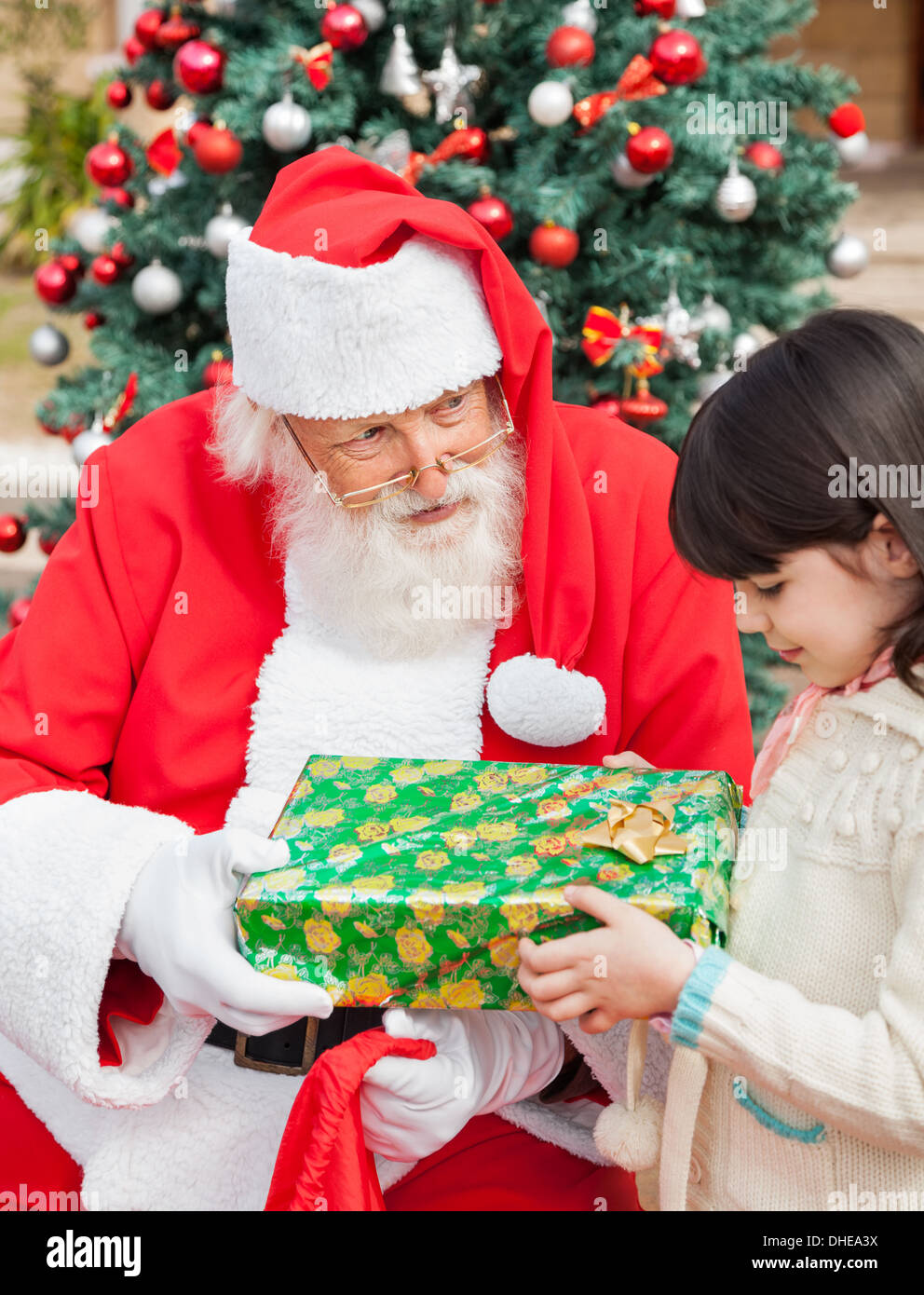 Santa Claus Giving Gift To Girl Stock Photo Alamy