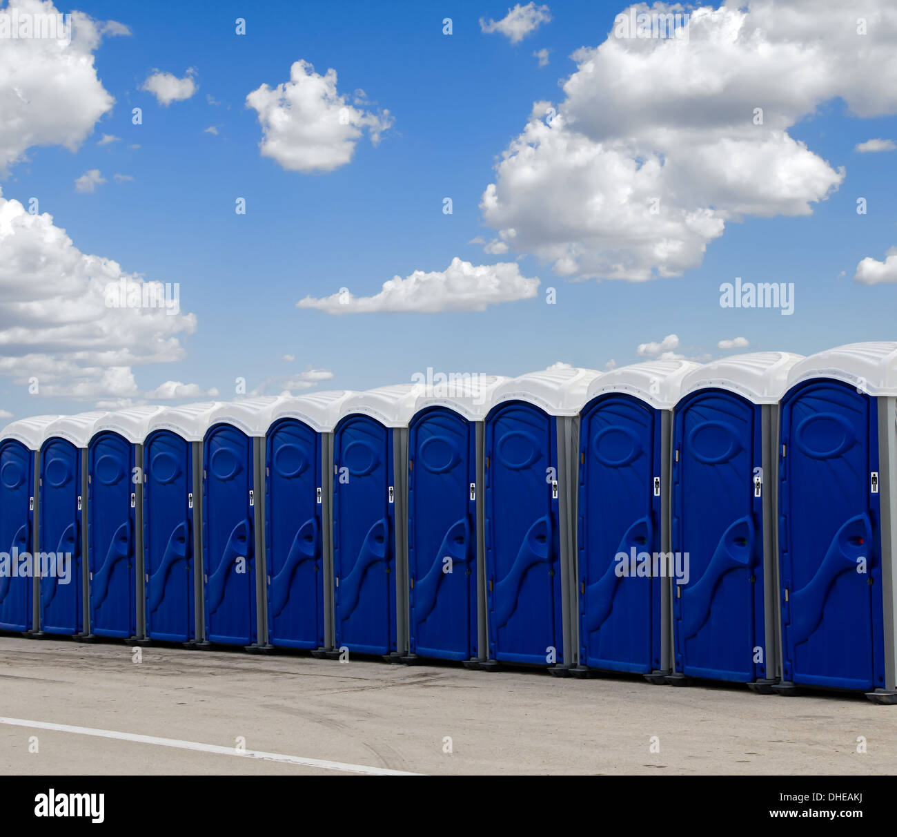 A row of blue portable toilets Stock Photo