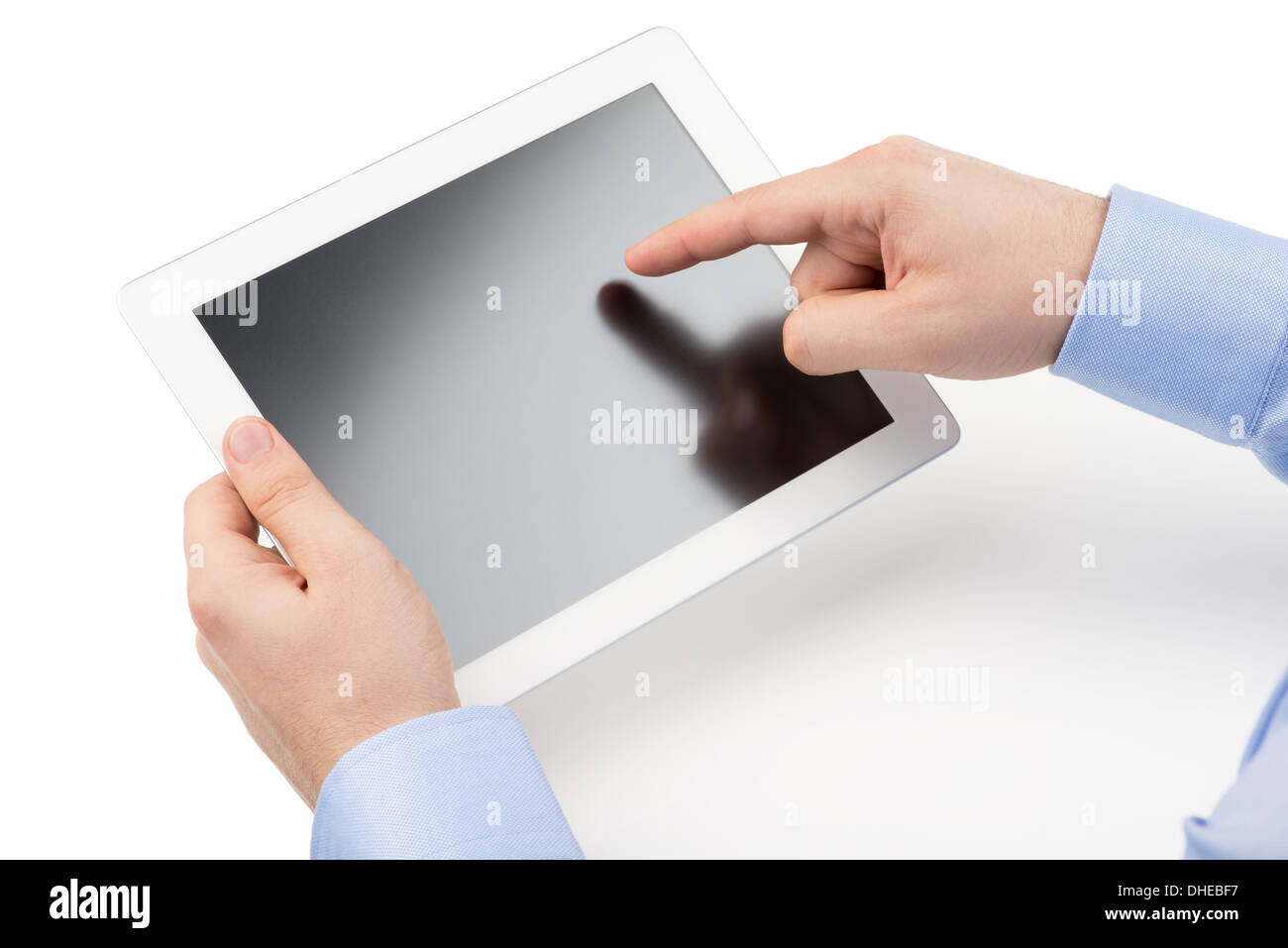 Man's hands are holding a tablet computer and points a finger at the screen on a white background. Stock Photo
