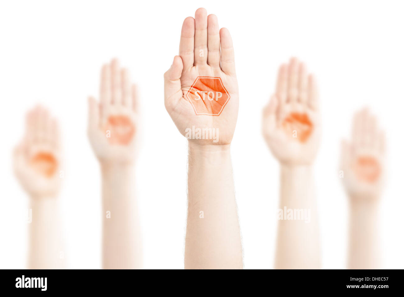 Hands raised to the sky on a white background, expression of protest. On the palms there is a sign — 'Stop'. Stock Photo