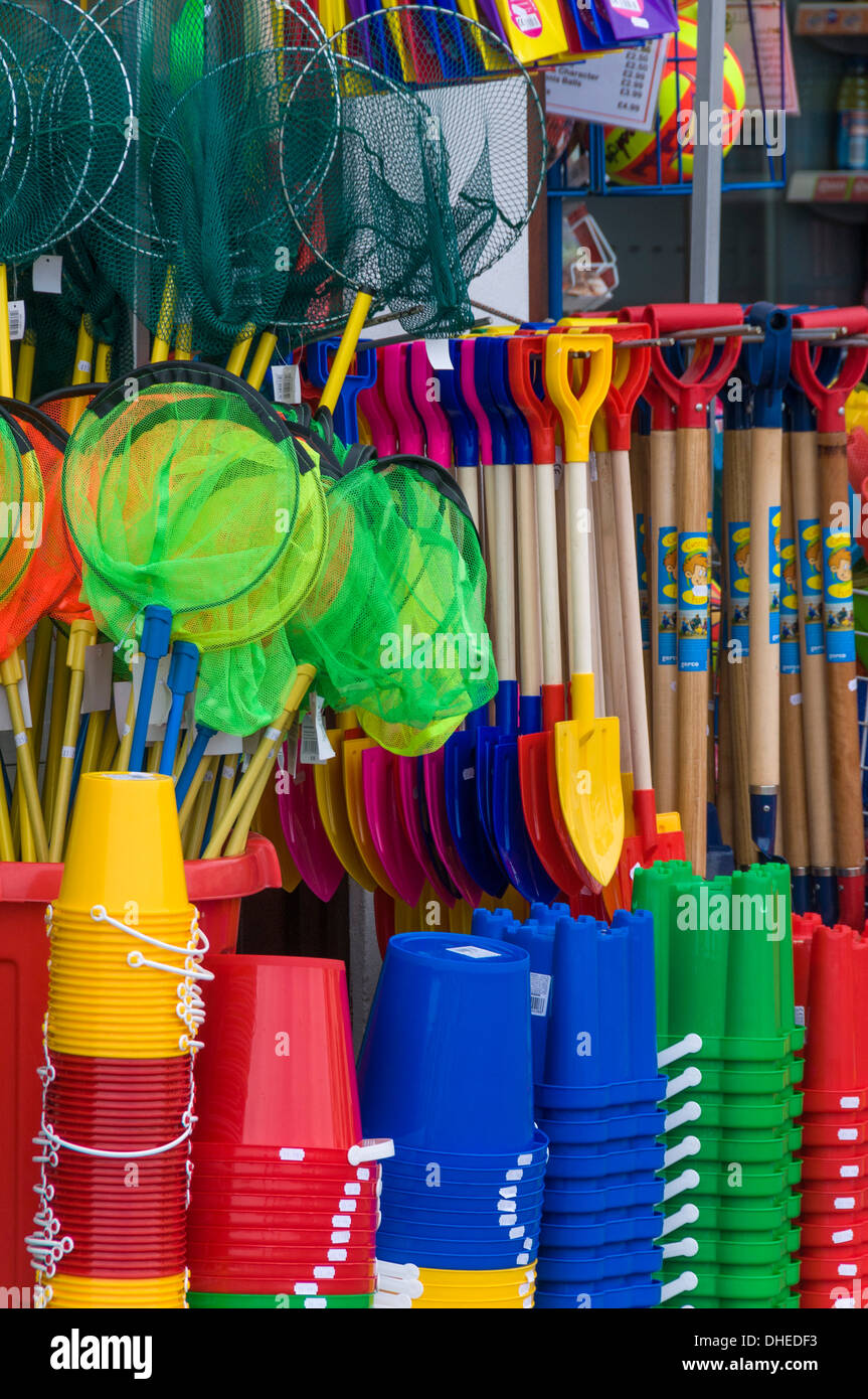 Traditional buckets and spades on sale in a seaside shop in Lyme Regis, Dorset, England, United