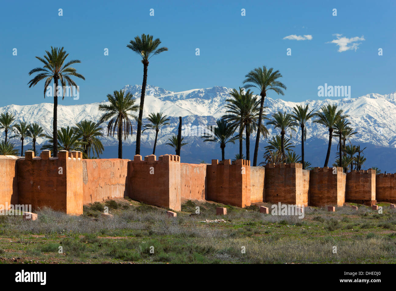 The old city walls and snow capped Atlas Mountains, Marrakech, Morocco, North Africa, Africa Stock Photo