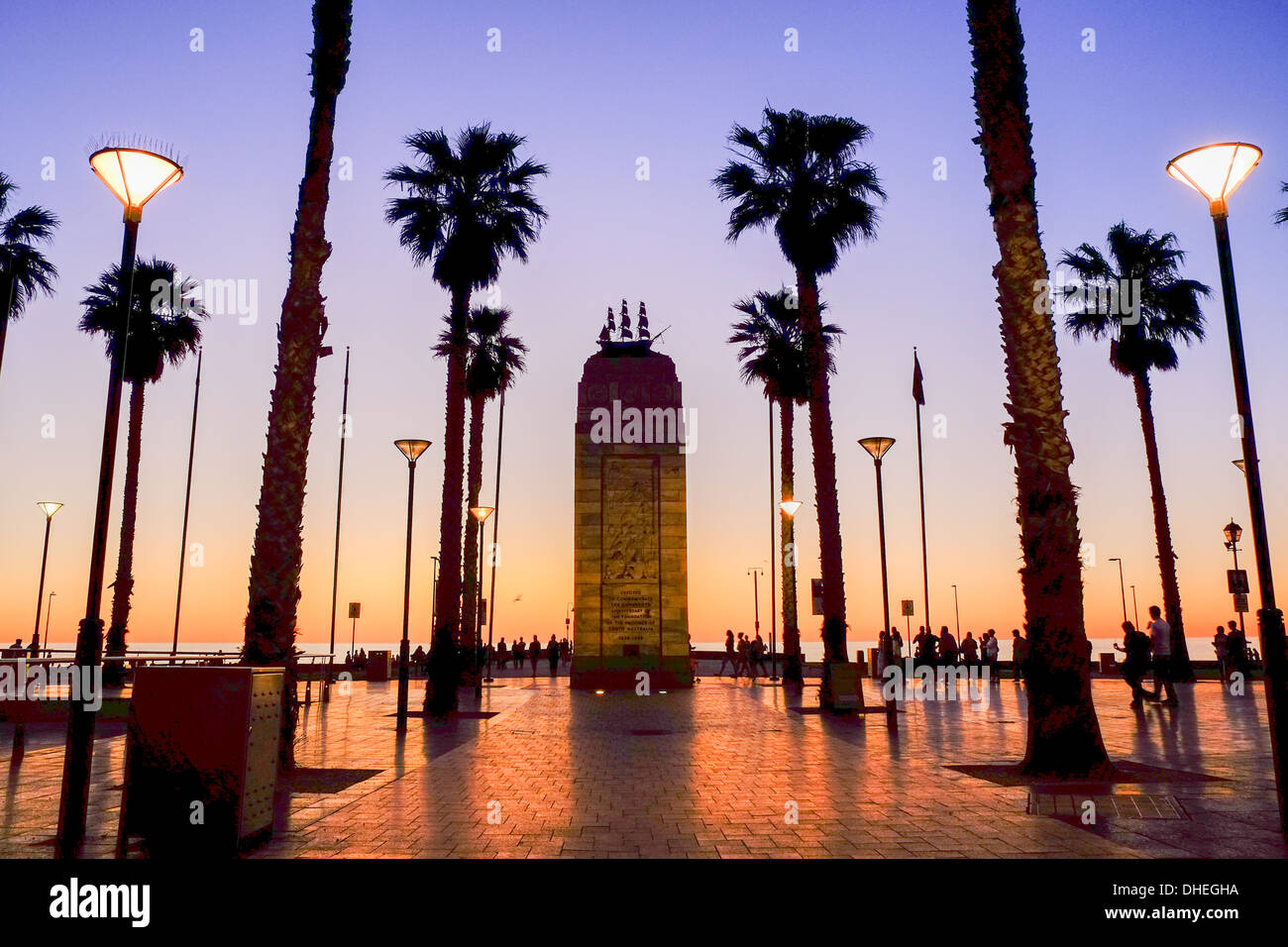 The monument and palms of Glenelg's Moseley Square in Adelaide silhouetted against the sunset. Stock Photo