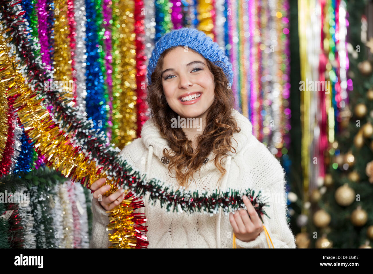 Young Woman Choosing Tinsels At Store Stock Photo