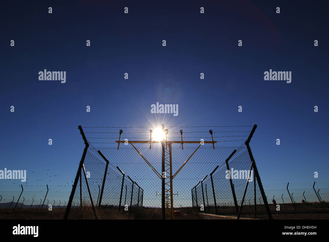 Airport runway lights behind a perimeter fence Stock Photo