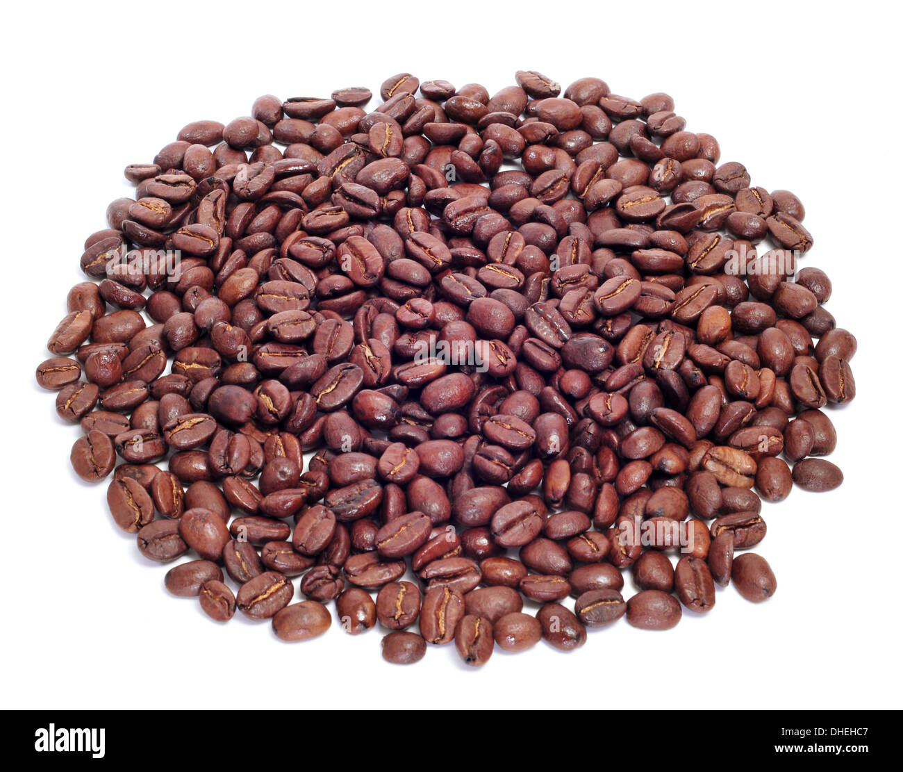 a pile of roasted coffee beans on a white background Stock Photo - Alamy
