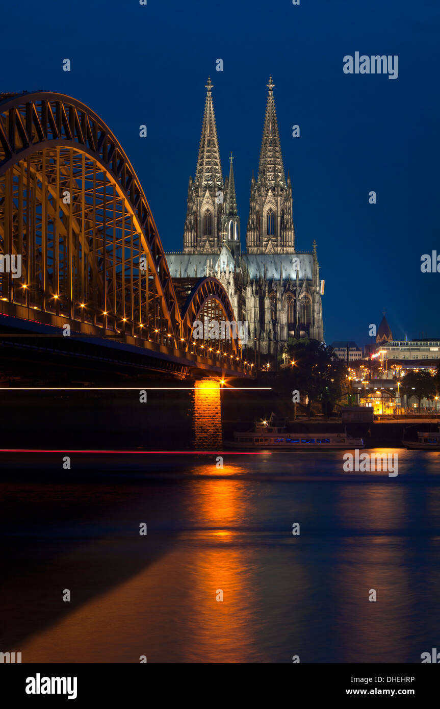 Cologne cathedral, UNESCO World Heritage Site, and Hohenzollern bridge at dusk, Cologne, Germany, Europe Stock Photo
