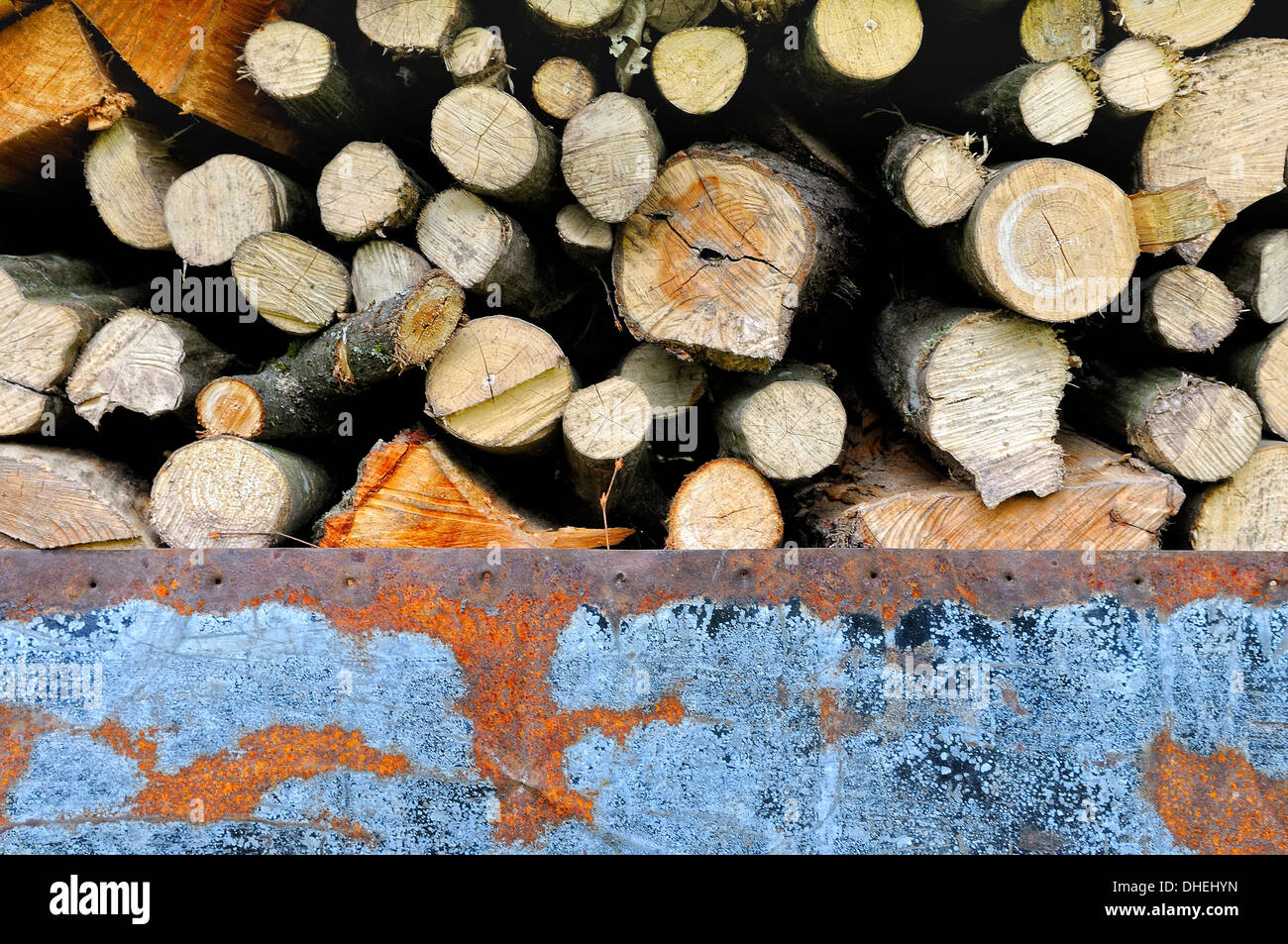 Covered firewood with an old sheet metal Stock Photo