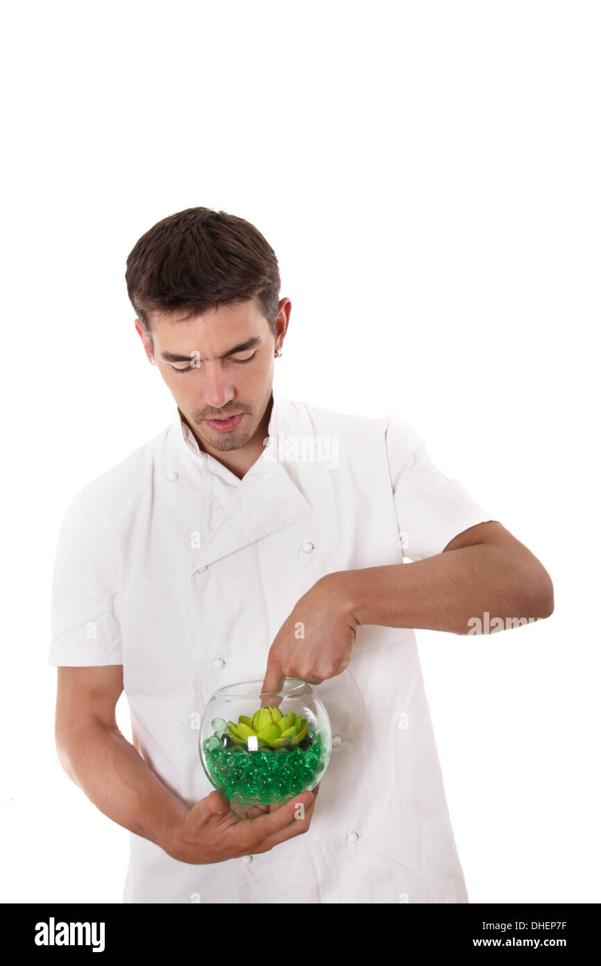 Cook preparing meal and stiring something in the bowl Stock Photo