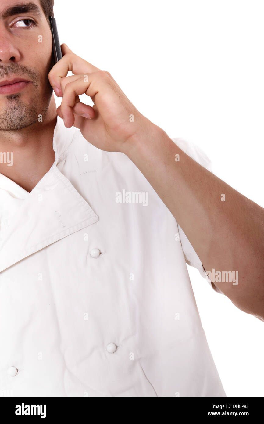 Cook in white overalls taking orders over the phone Stock Photo