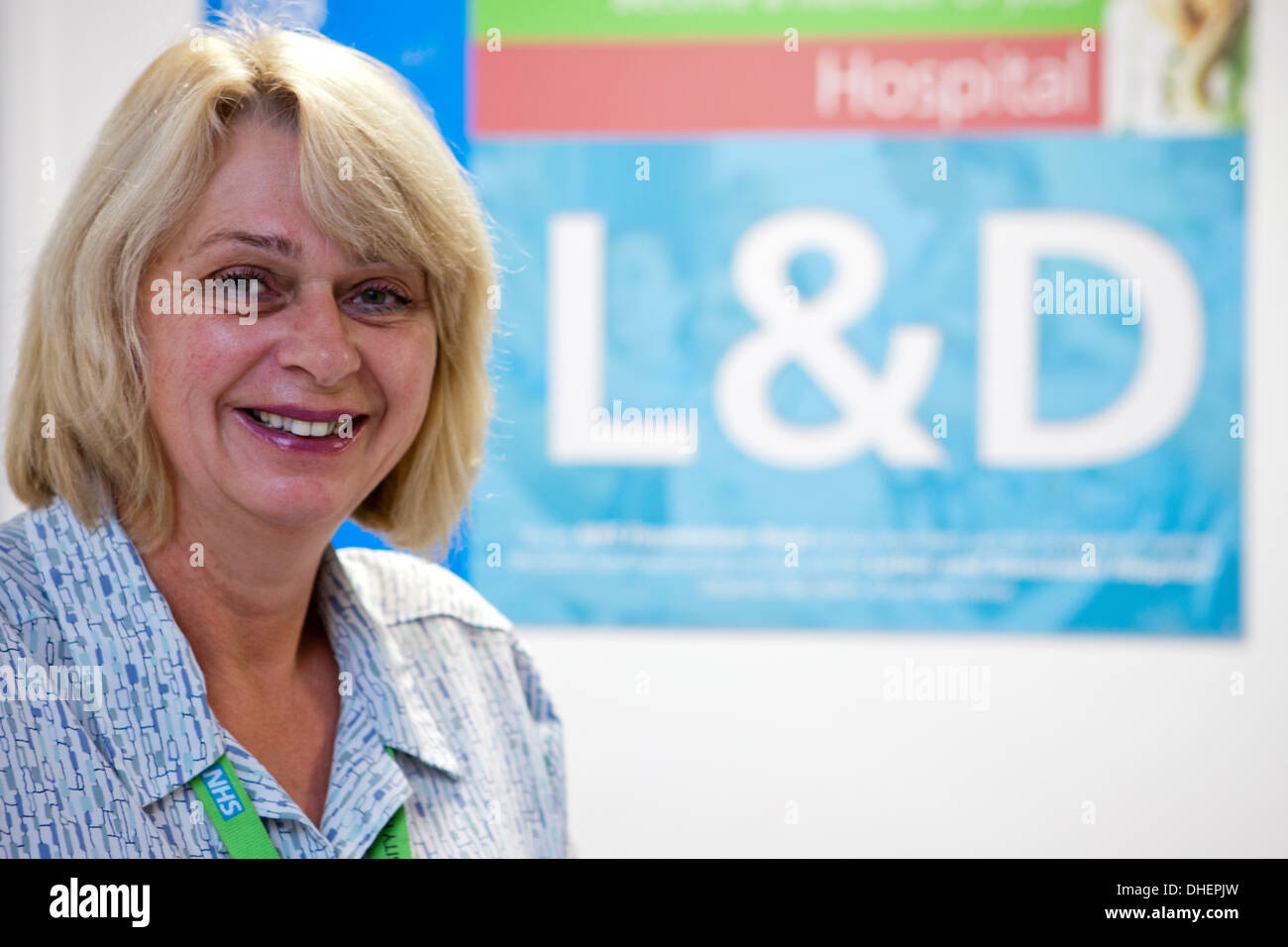 A receptionist welcomes patients to the Luton and Dunstable hospital UK Stock Photo