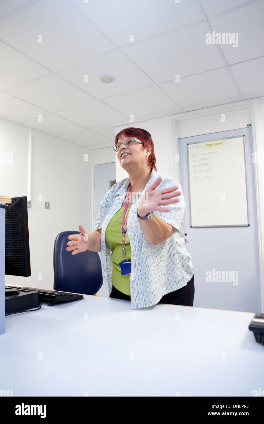 A female receptionist at an outpatient clinic UK Stock Photo