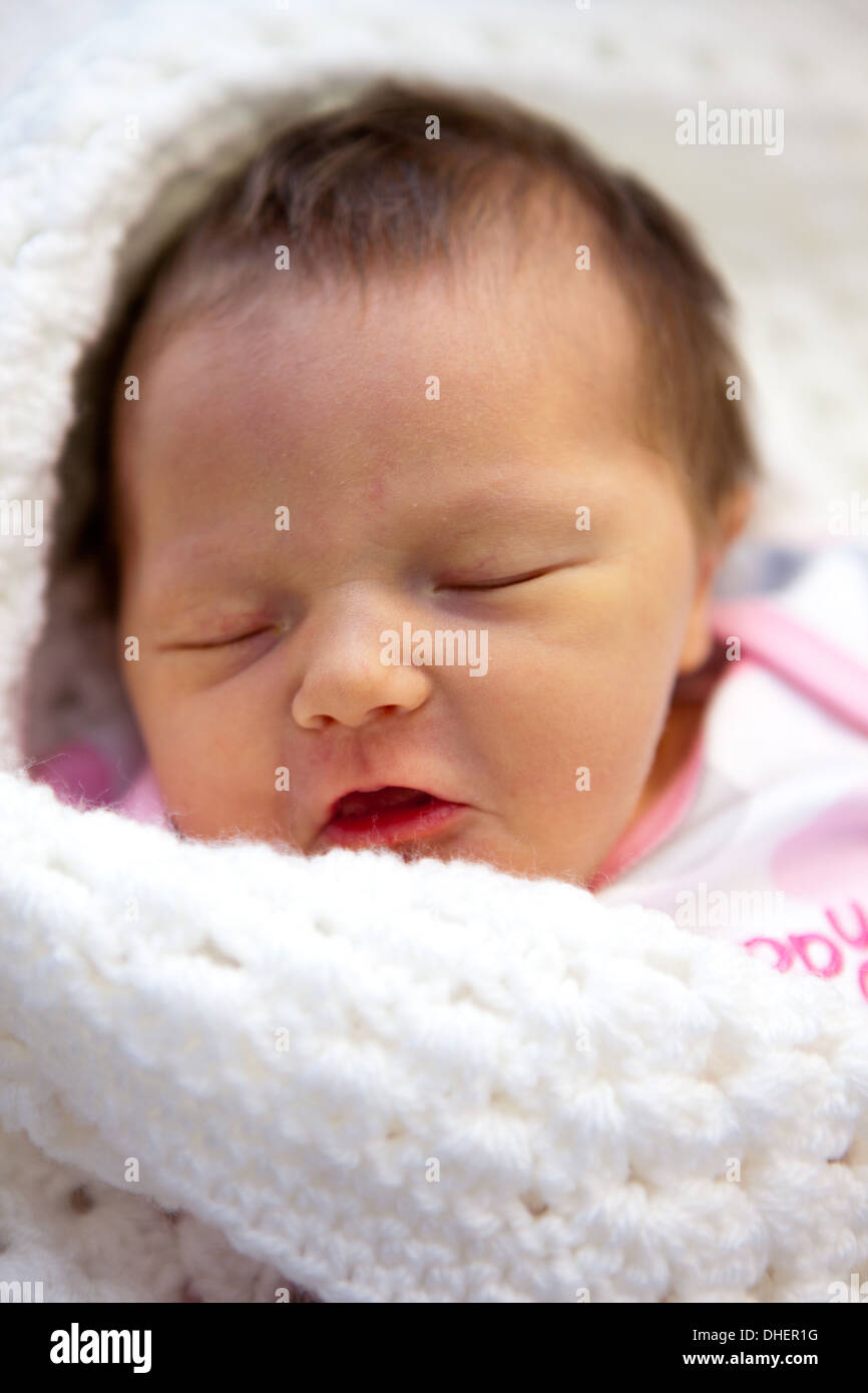 A newborn baby girl sleeps in her cot in the Luton and Dunstable Stock