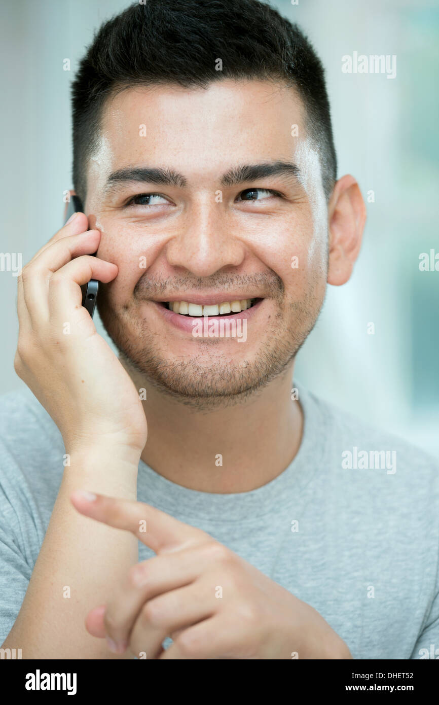 Mid adult man on telephone call, pointing Stock Photo