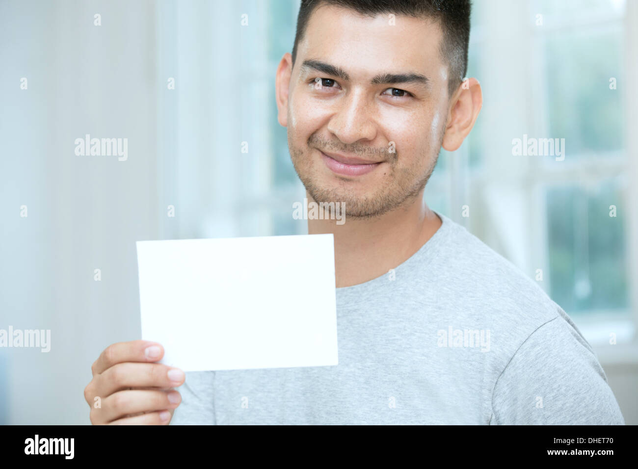 Mid adult man holding a blank card Stock Photo