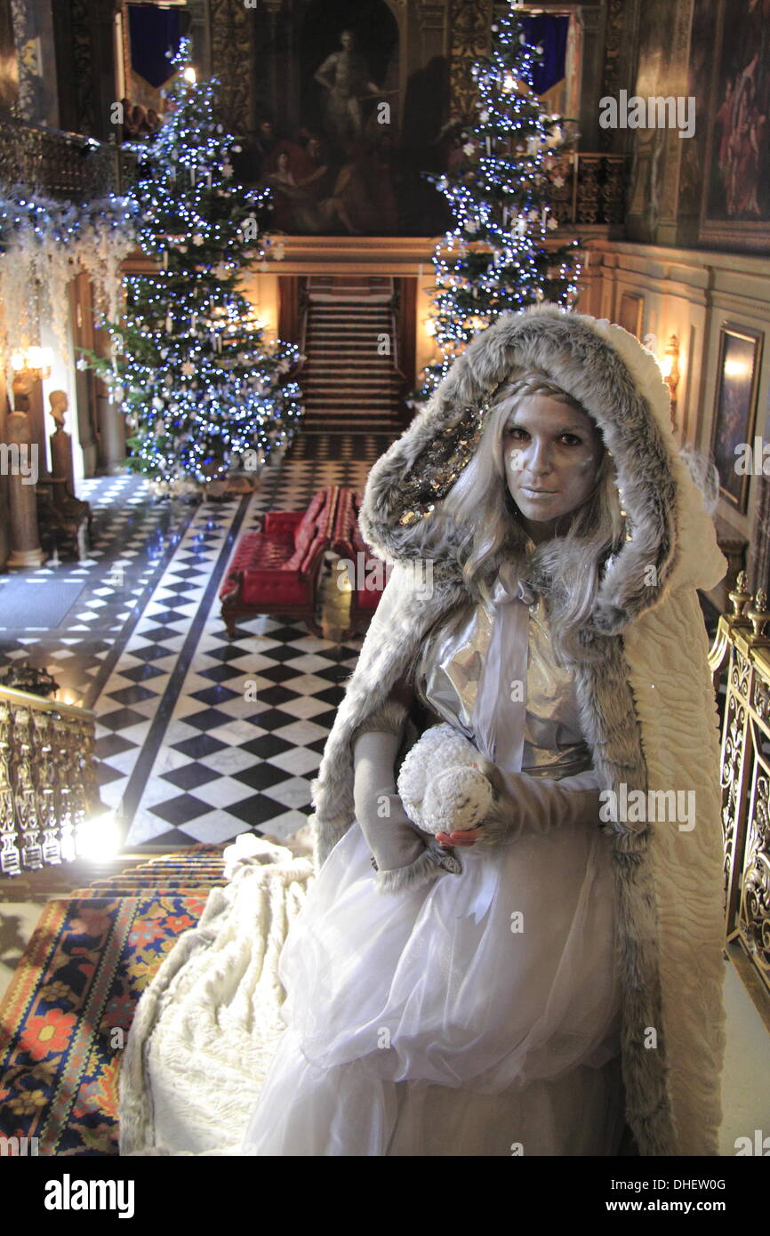 Peak District, Derbyshire, UK. 8 Nov 2013.  The White Witch in Chatsworth's Painted Hall.  The Painted Hall has fallen under the icy grip of The White Witch to become her Palace.  She wears a 25ft long cape that is one of around 100 costumes created by the Chatsworth Textile Team for this year's Christmas theme.  The Magical Land of Narnia at Chatsworth opens to the public Sat 9 Nov.  and runs until 23 Dec.  2013 with costumed guides to bring the story to life. Credit:  Matthew Taylor/Alamy Live News Stock Photo