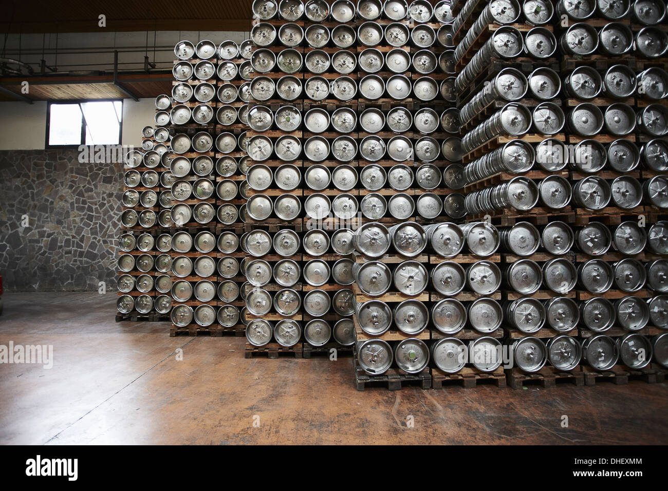 Casks of beer stacked in a brewery Stock Photo