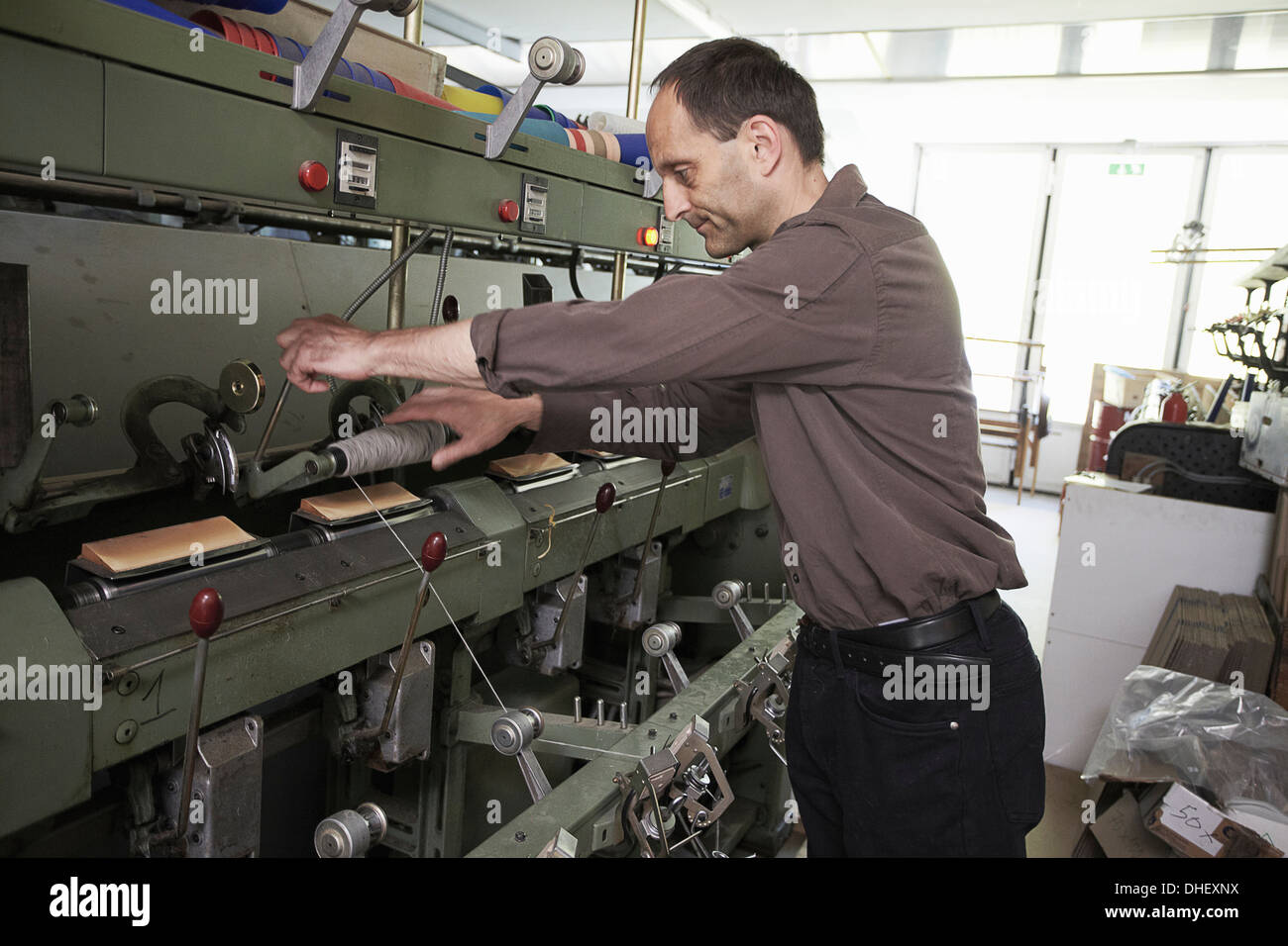 Worker using machine in wool factory Stock Photo