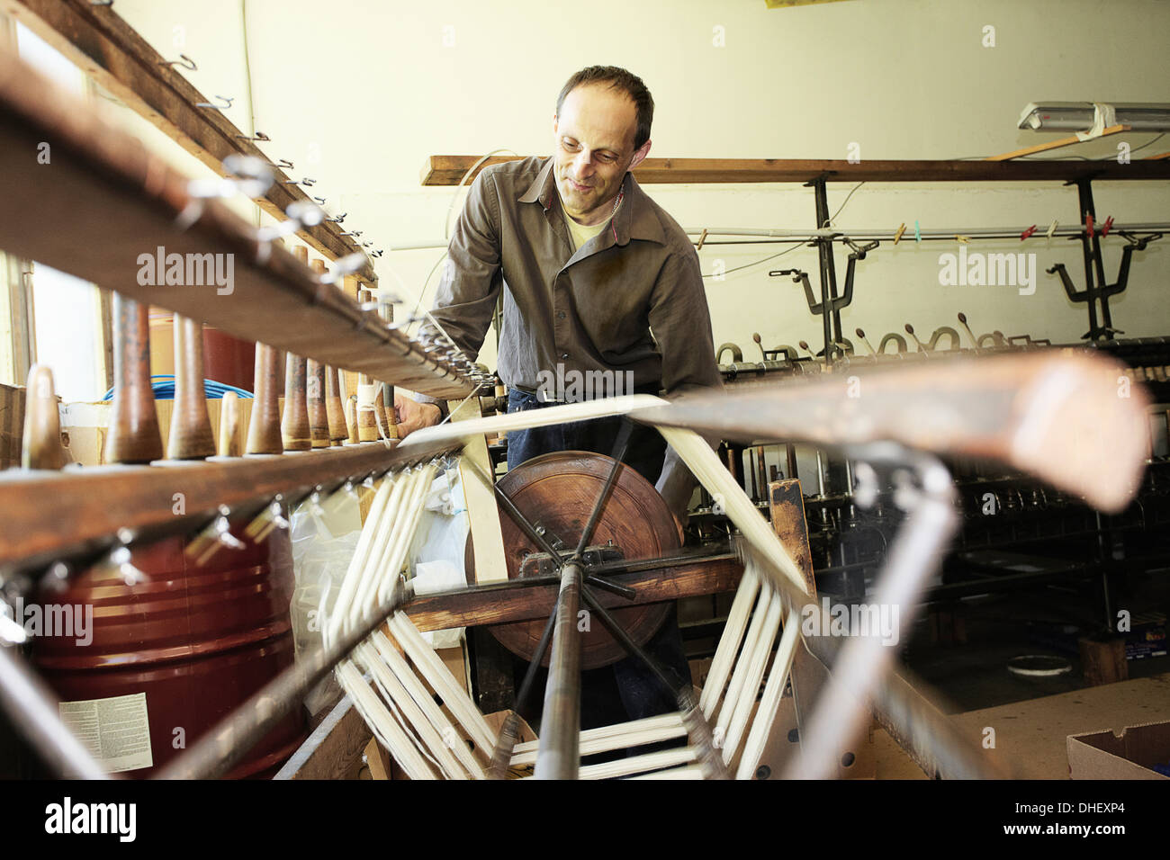 Worker using loom in wool factory Stock Photo
