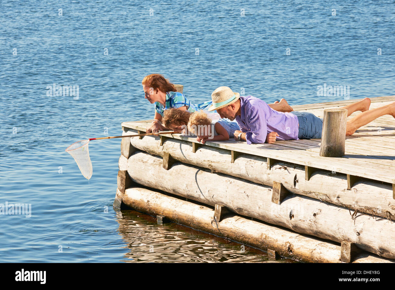 Family fishing on pier, Utvalnas, Gavle, Sweden Stock Photo