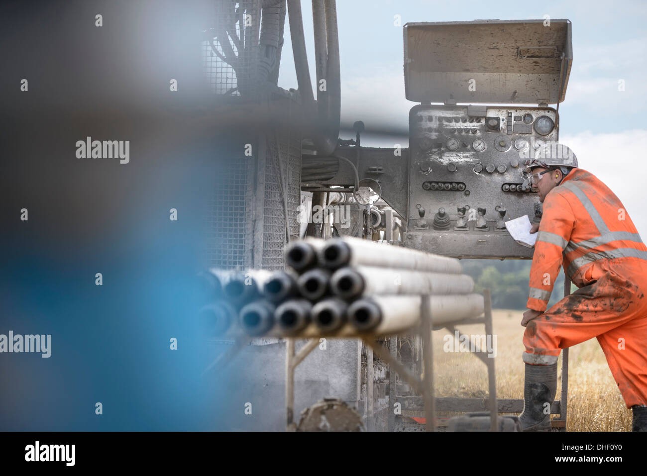 Drilling rig worker inspecting machinery Stock Photo