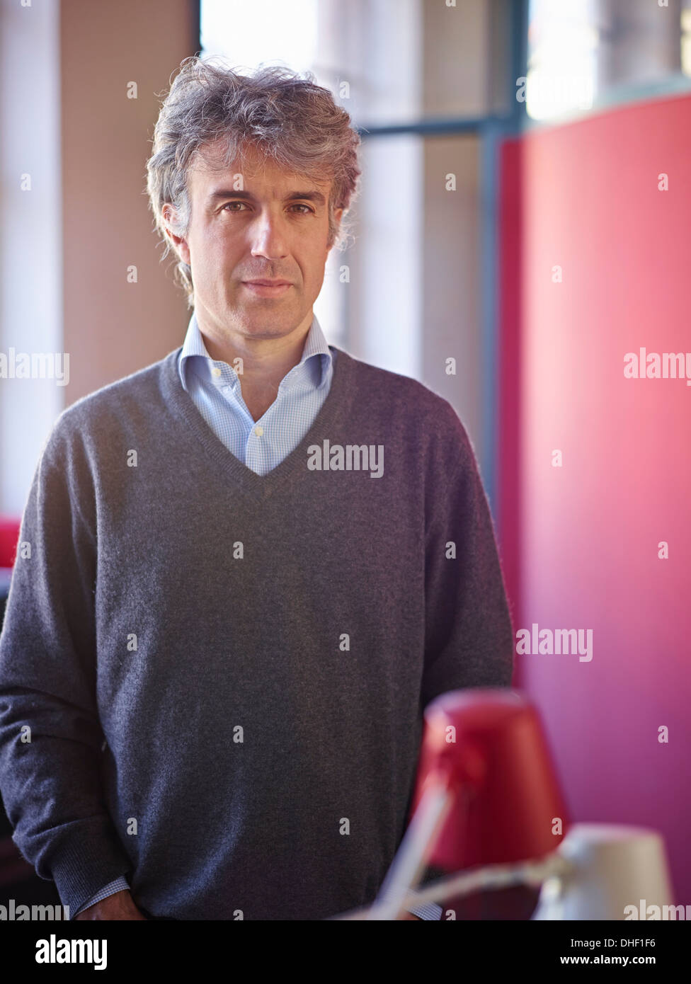 Portrait of mature businessman wearing grey jumper Stock Photo
