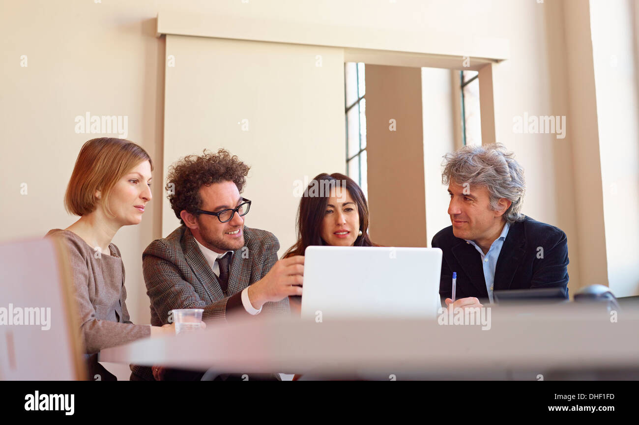 Office colleagues in meeting using laptop Stock Photo