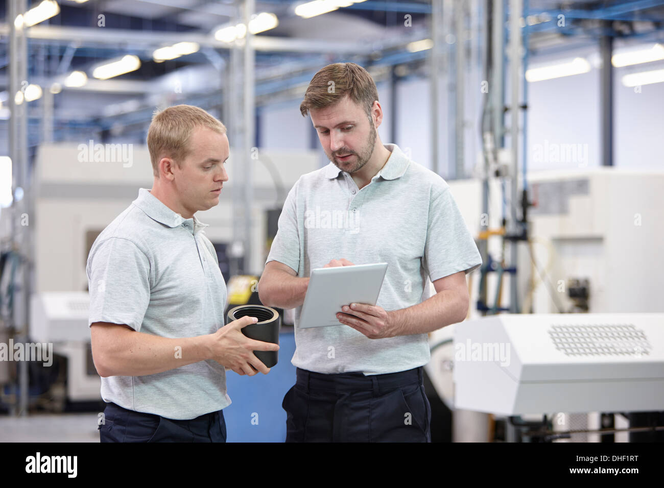 Two workers looking at digital tablet in engineering warehouse Stock Photo